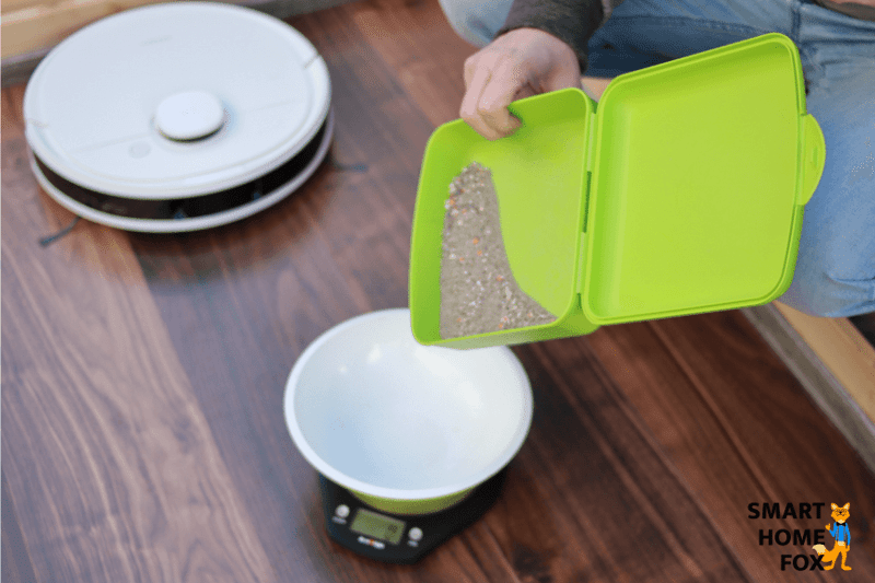 Weighing out dirt on a scale for the cleaning test